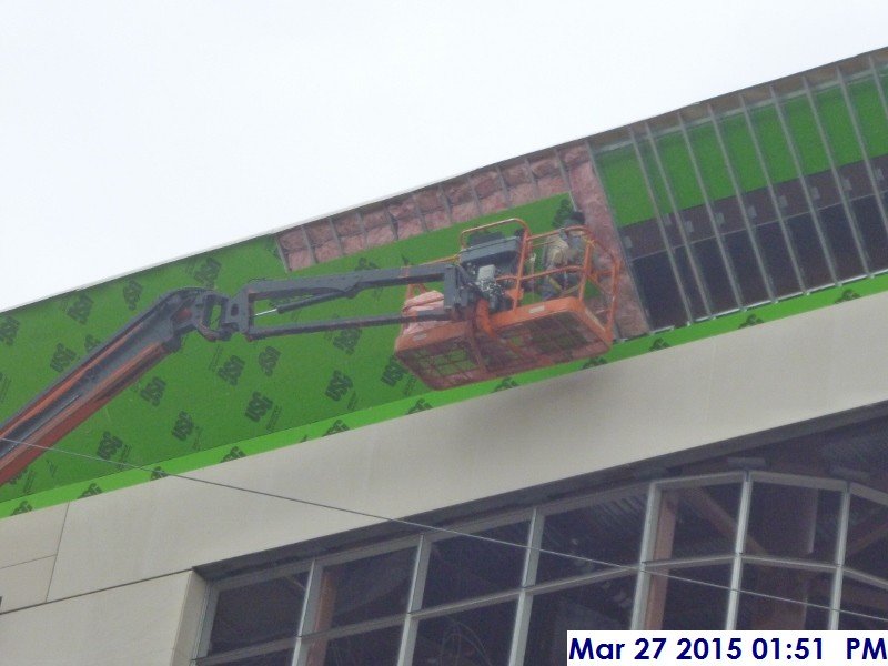 Continued sheathing and installing insulation at the parapet (South Elevation)